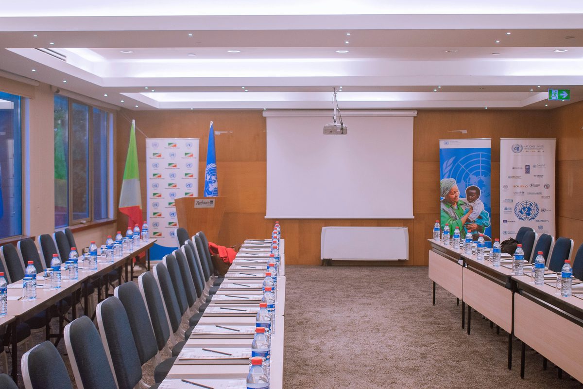 Conference room laid out for delegates with a projector screen
